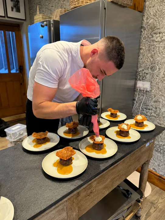 A bespoke catered dining experience being plated at The Old Rectory